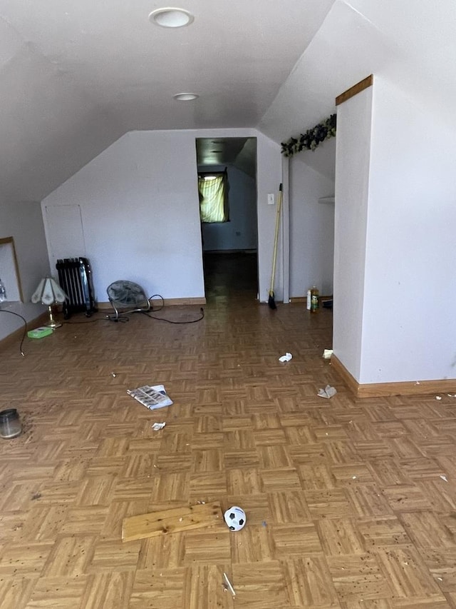 bonus room with light parquet floors and lofted ceiling