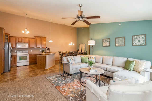 living room with ceiling fan with notable chandelier