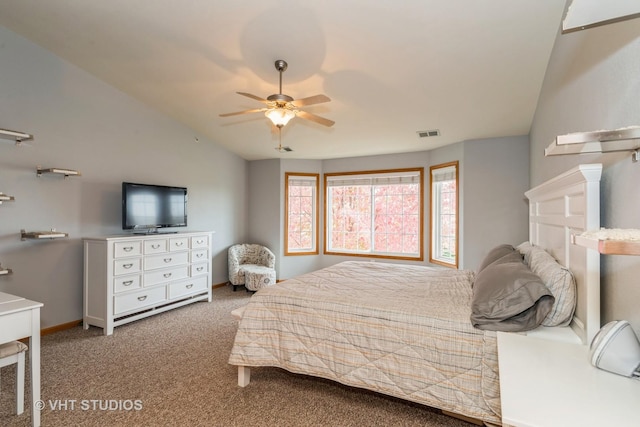 carpeted bedroom with ceiling fan and vaulted ceiling