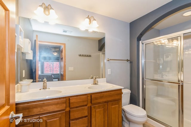 bathroom with vanity, toilet, and walk in shower