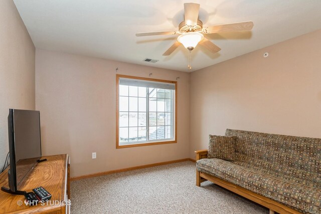 living area with carpet flooring and ceiling fan