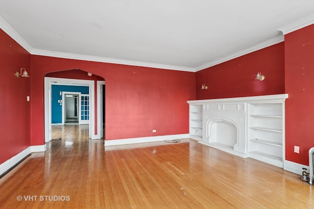 7730 S E End Ave, Chicago, IL 60649 - unfurnished living room featuring arched walkways, wood finished floors, baseboards, crown molding, and built in features