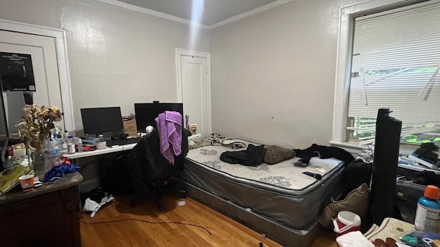 bedroom featuring hardwood / wood-style flooring and ornamental molding