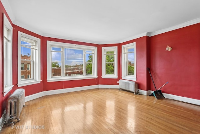 7730 S E End Ave, Chicago, IL 60649 - empty room featuring radiator, baseboards, wood finished floors, and ornamental molding