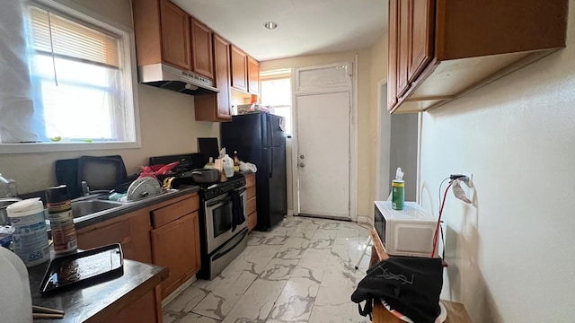 kitchen with black fridge and stainless steel range oven