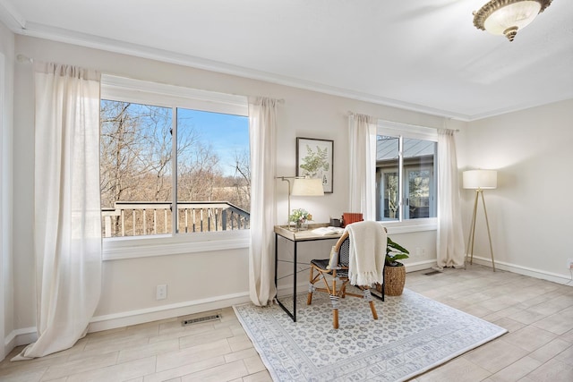 office space featuring baseboards, visible vents, ornamental molding, and wood finish floors