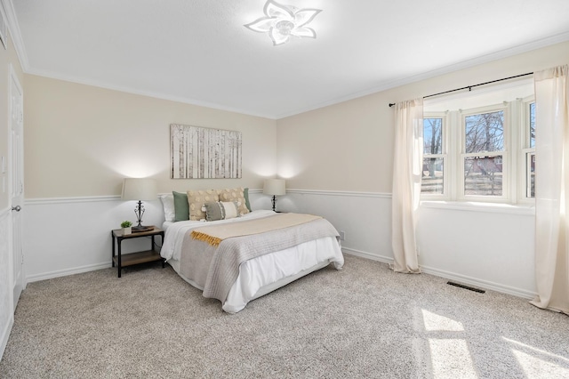 bedroom featuring ornamental molding, visible vents, and baseboards