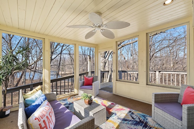 sunroom / solarium with wooden ceiling, plenty of natural light, and ceiling fan