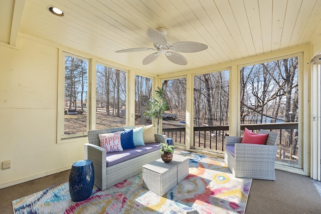 sunroom with ceiling fan and wooden ceiling