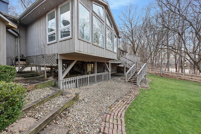 view of property exterior featuring stairway and a yard