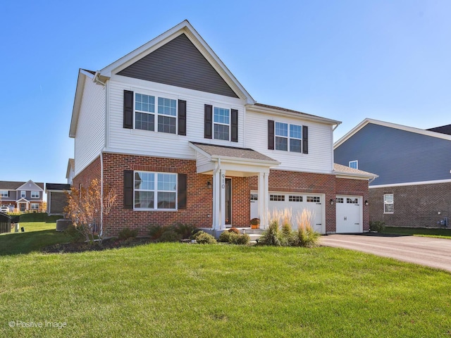 view of front of home with a front lawn and a garage