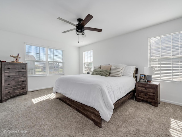 bedroom with ceiling fan and light carpet