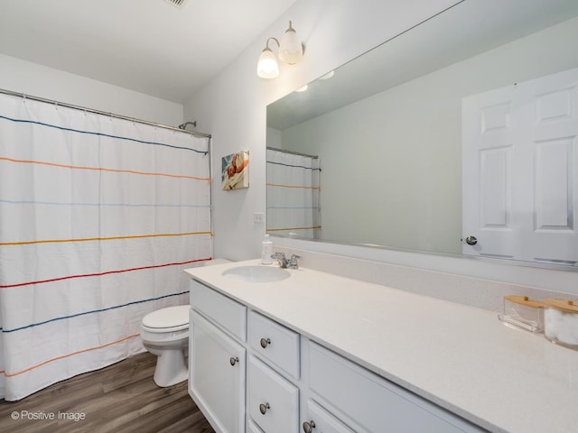 bathroom with vanity, hardwood / wood-style flooring, and toilet