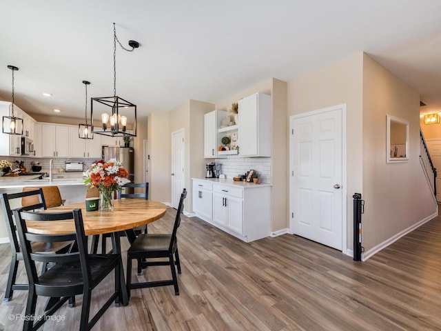 dining area featuring an inviting chandelier and hardwood / wood-style flooring