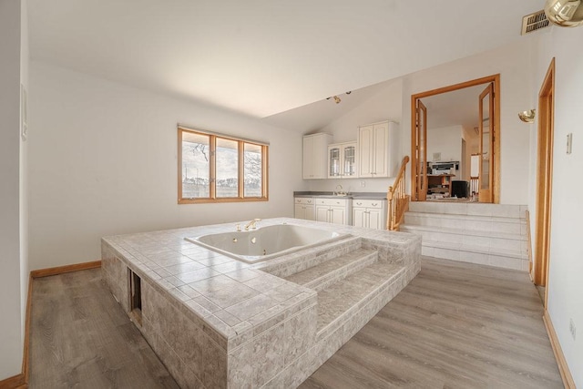 17043 Annetta Ave, Hazel Crest, IL 60429 - kitchen featuring tile countertops, white cabinetry, vaulted ceiling, light wood-style floors, and baseboards