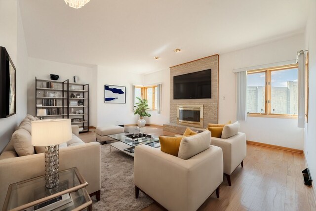 17043 Annetta Ave, Hazel Crest, IL 60429 - living room featuring wood finished floors, a brick fireplace, and baseboards