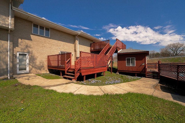 rear view of house with a wooden deck and a storage unit