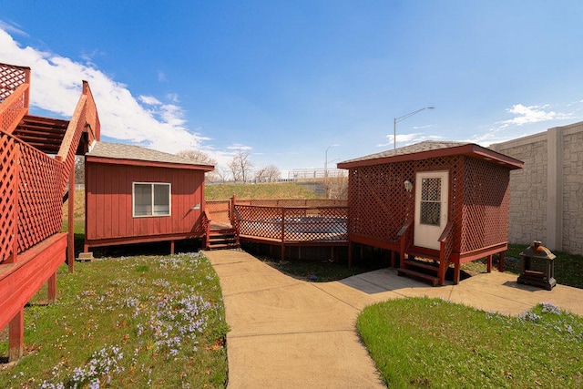 exterior space featuring an outbuilding and a deck