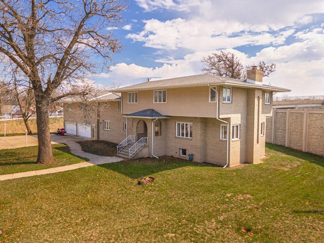 back of property with a yard and a garage