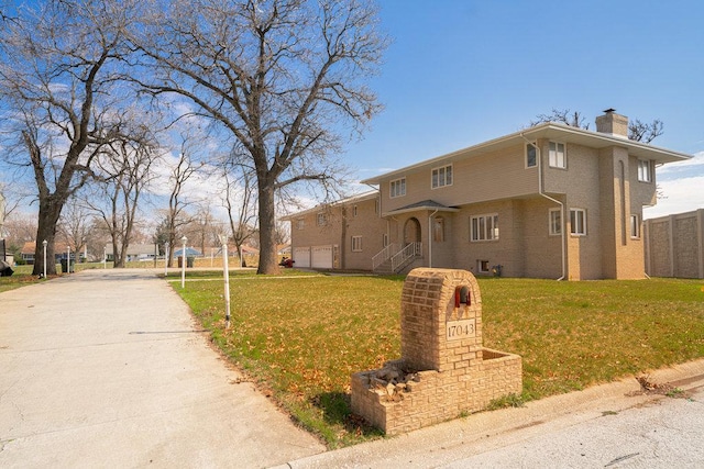 view of front of property with a garage and a front yard