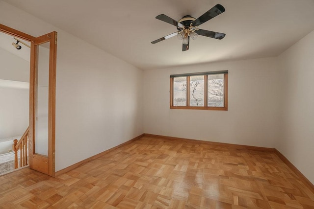 empty room with baseboards and a ceiling fan