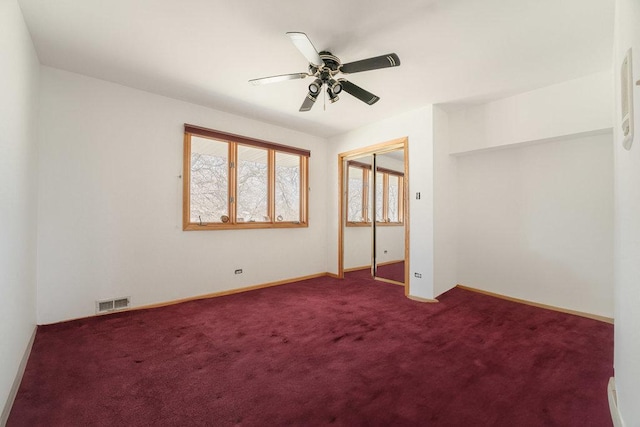 unfurnished bedroom with carpet floors, a closet, visible vents, ceiling fan, and baseboards