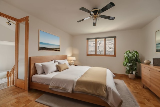 bedroom featuring ceiling fan and light parquet flooring