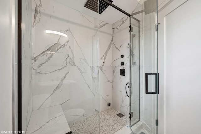 bathroom featuring a shower with door