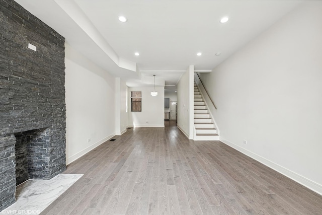 unfurnished living room with a fireplace and hardwood / wood-style flooring