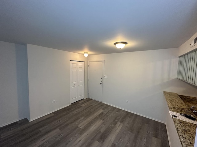 empty room with dark hardwood / wood-style floors