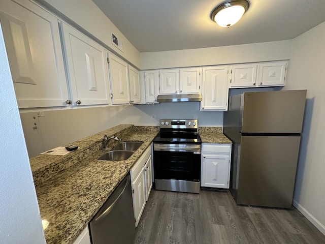 kitchen with stone counters, white cabinetry, sink, and stainless steel appliances