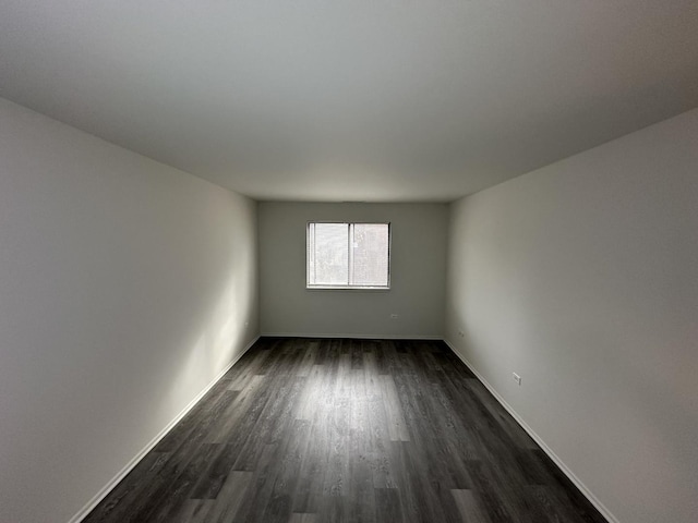 unfurnished room featuring dark wood-type flooring