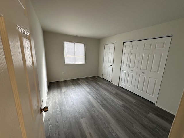 unfurnished bedroom featuring dark hardwood / wood-style floors