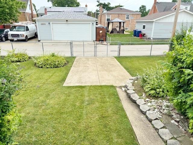 1429 N Wolf Rd, Berkeley, IL 60163 - view of yard with a garage, a gate, and a gazebo