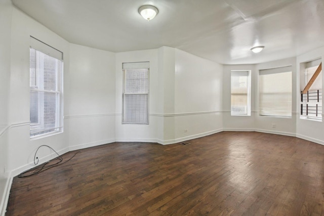 unfurnished room featuring dark hardwood / wood-style flooring