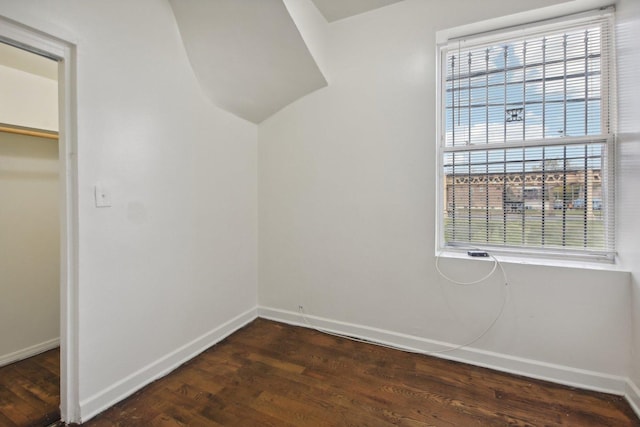 bonus room featuring plenty of natural light and dark wood-type flooring