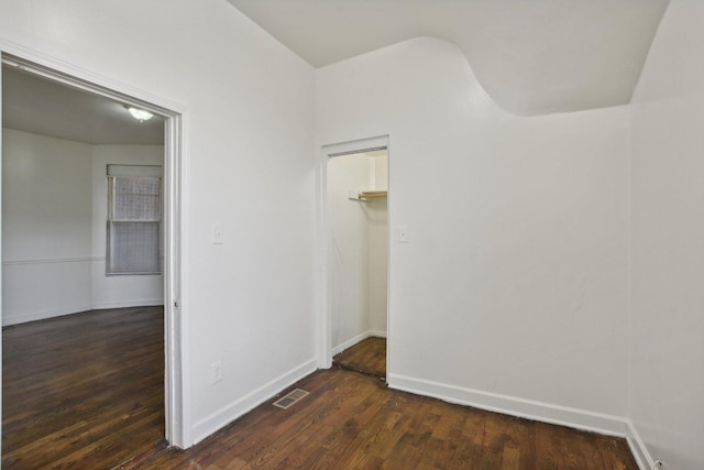 spare room featuring dark wood-type flooring