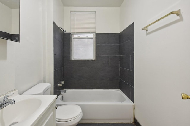 full bathroom with vanity, tiled shower / bath combo, and toilet