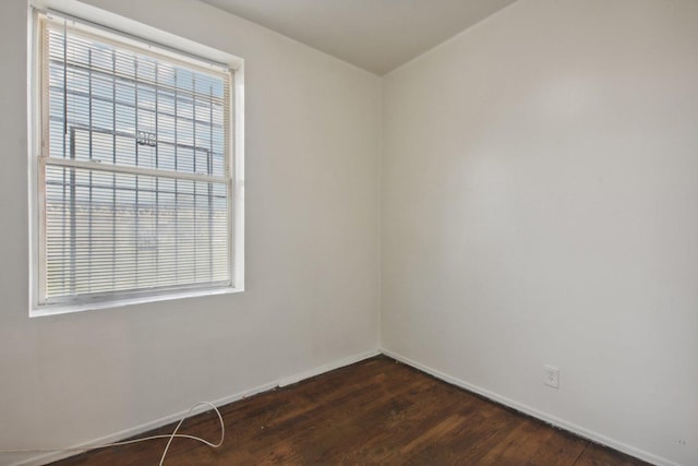 spare room featuring dark hardwood / wood-style floors