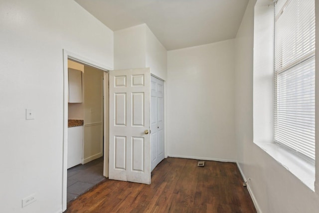 hallway with dark hardwood / wood-style flooring