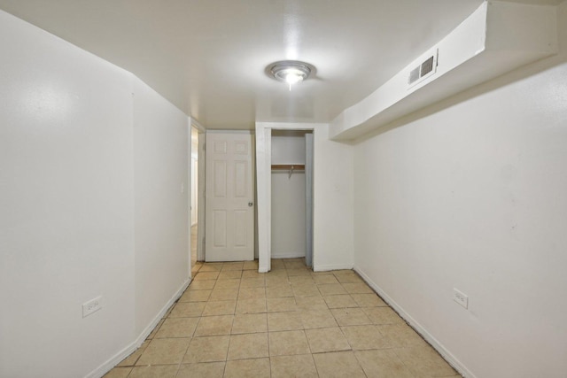 unfurnished bedroom with a closet and light tile patterned floors