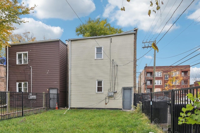 back of property with a lawn