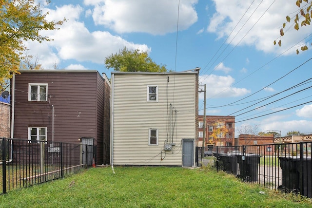 rear view of house featuring a lawn