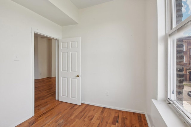 spare room featuring wood-type flooring