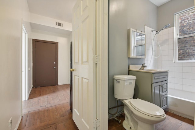 full bathroom featuring shower / tub combination, toilet, vanity, and hardwood / wood-style flooring