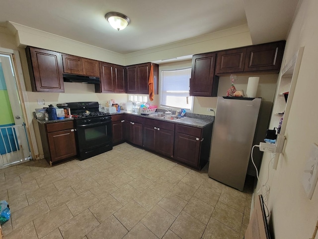 kitchen with stainless steel fridge, black gas stove, and sink