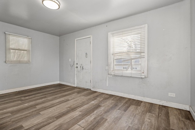 spare room with hardwood / wood-style floors and a healthy amount of sunlight