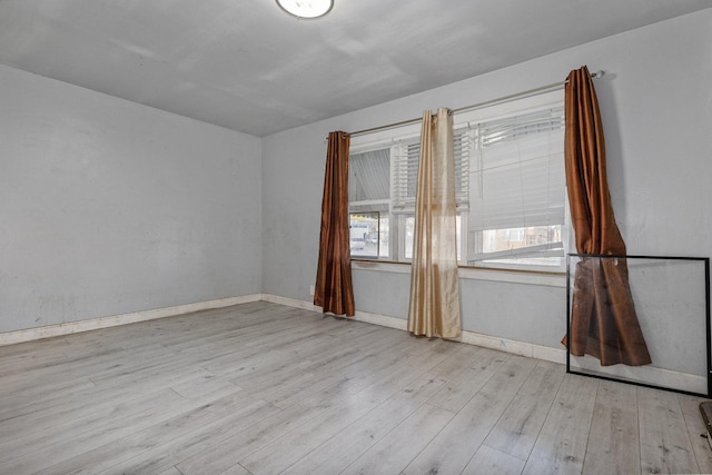 unfurnished room with light hardwood / wood-style flooring