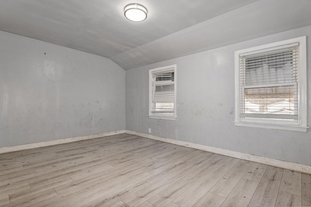 bonus room with vaulted ceiling and light hardwood / wood-style floors