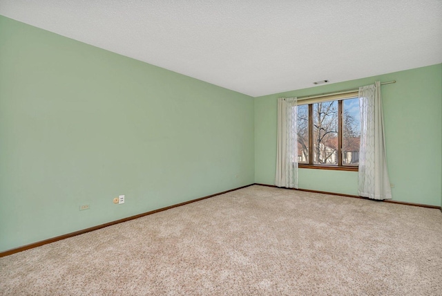 carpeted spare room featuring a textured ceiling